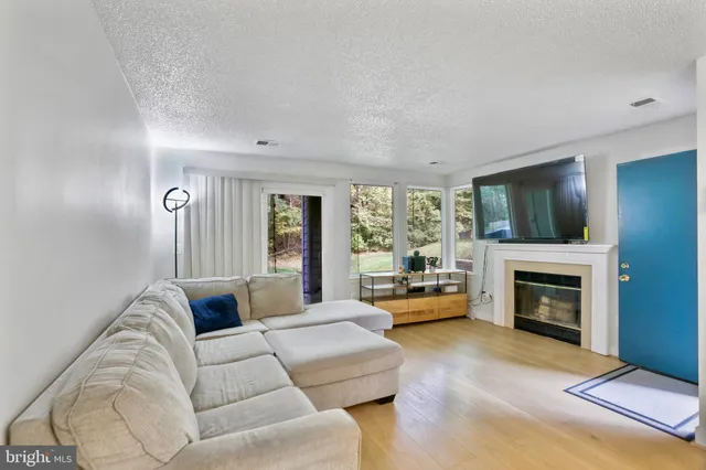 a living room with furniture fireplace and flat screen tv