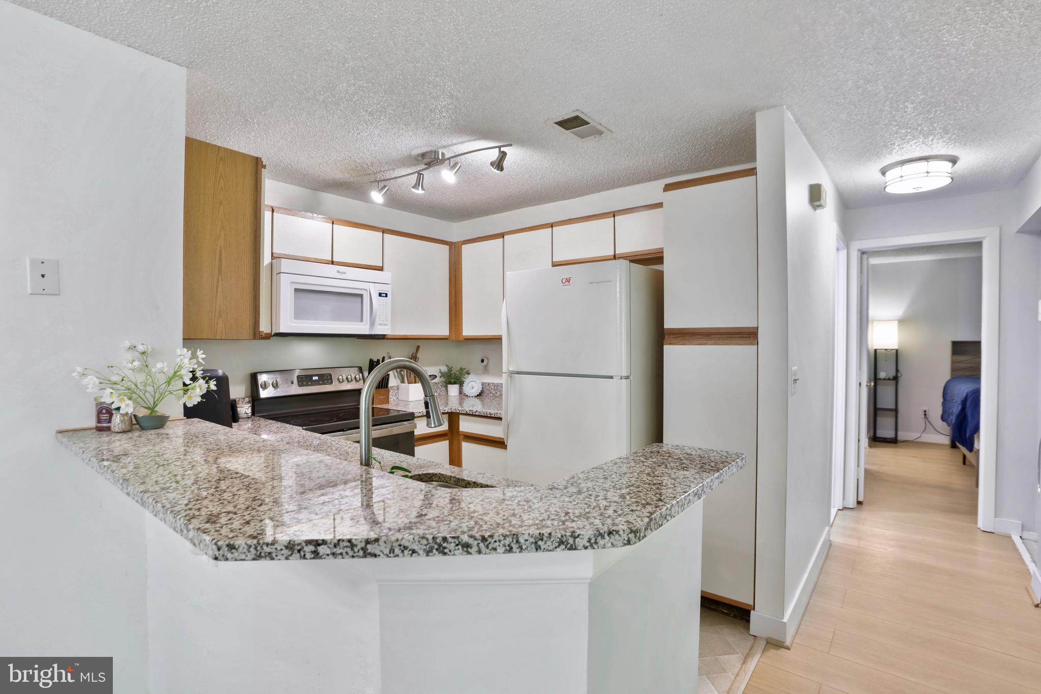 11723 Summerchase Circle Reston, VA 20194 - Photo 8 of 22 a kitchen with sink refrigerator and microwave