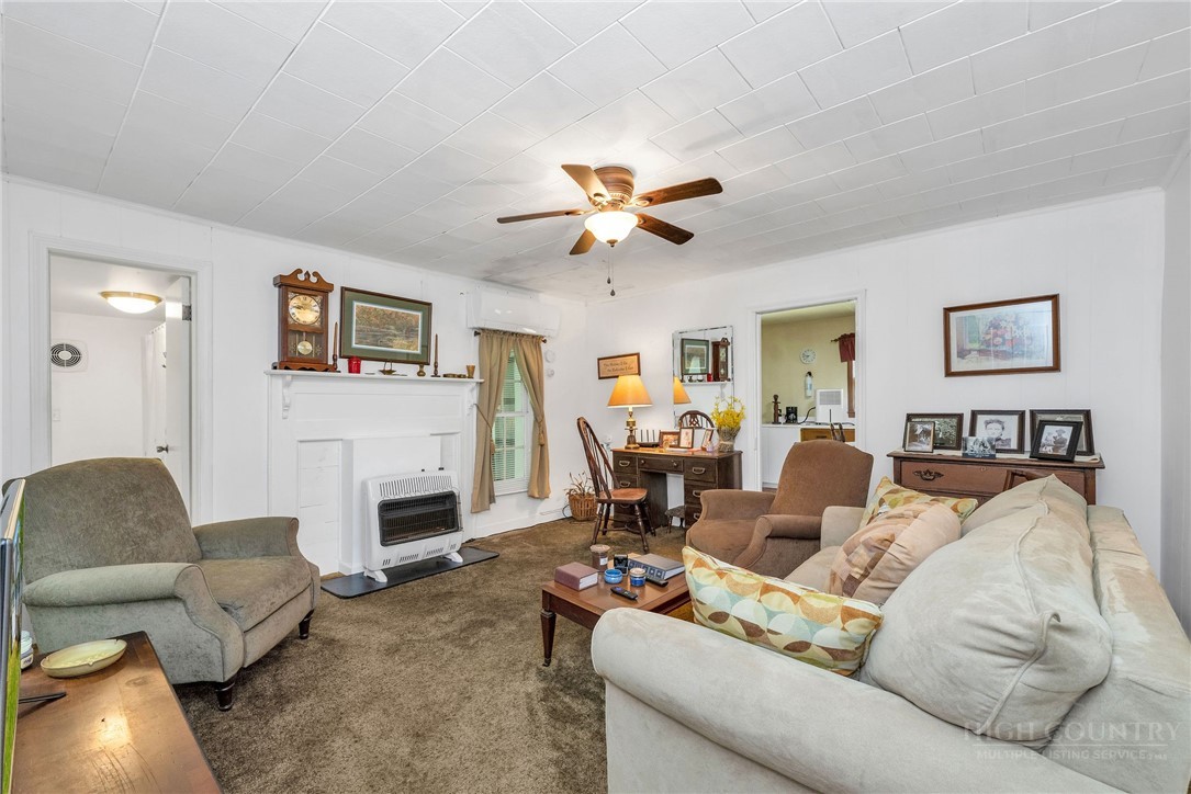 2284 Idlewild Road West Jefferson, NC 28694 - Photo 12 of 23 a living room with furniture white walls and a fireplace