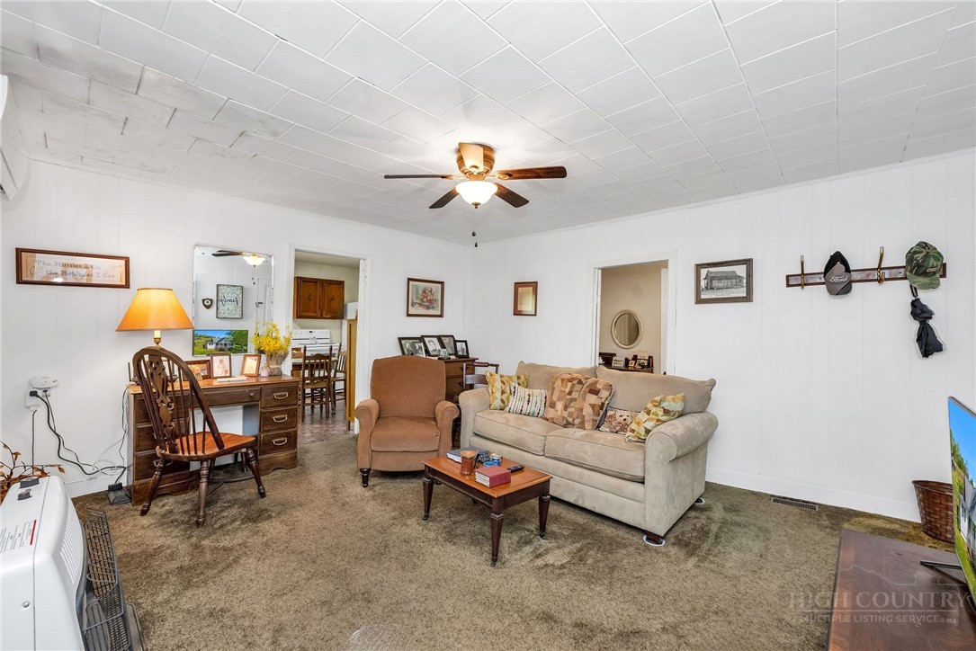 2284 Idlewild Road West Jefferson, NC 28694 - Photo 13 of 23 a living room with furniture a chandelier and a window