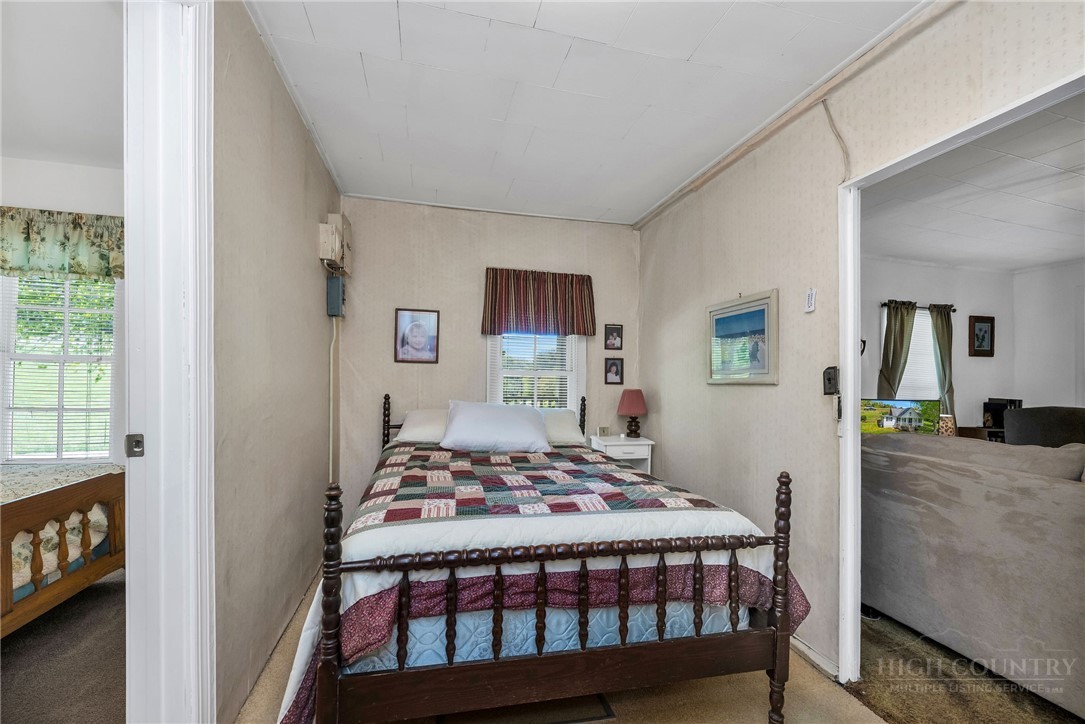 2284 Idlewild Road West Jefferson, NC 28694 - Photo 19 of 23 a bedroom that has a bed and a table in it