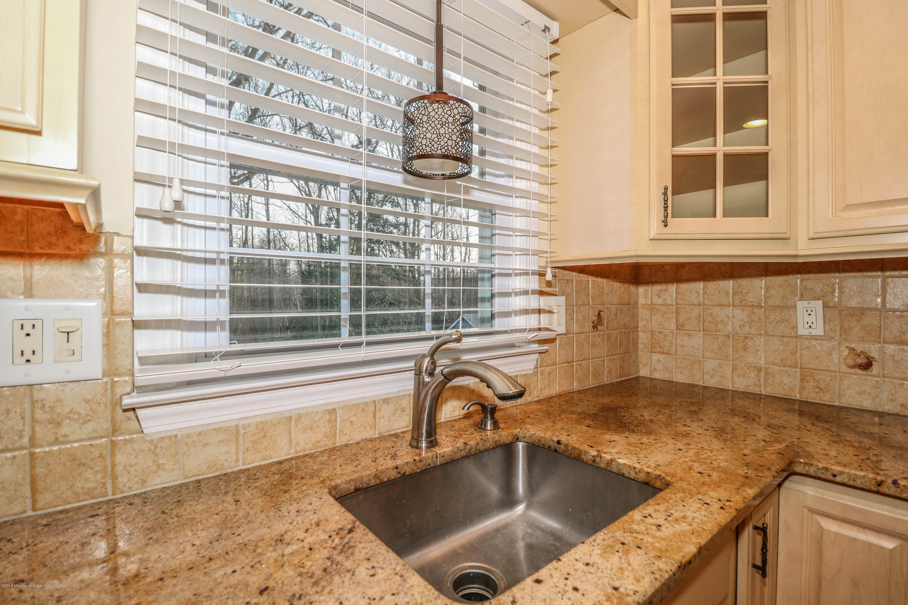 15 Middlebrook Drive Asbury Park, NJ 07712 - Photo 17 of 39 a bathroom with a granite countertop sink and a window