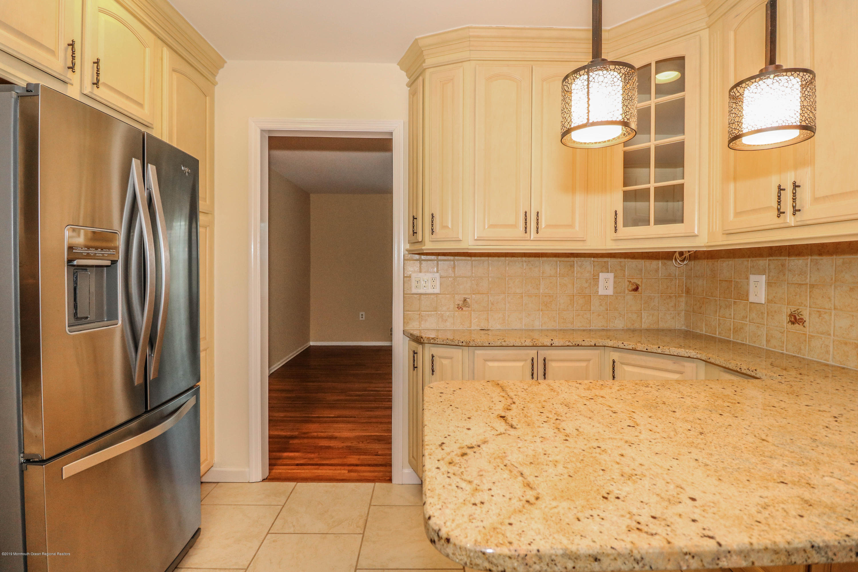 15 Middlebrook Drive Asbury Park, NJ 07712 - Photo 18 of 39 a view of a refrigerator in kitchen and wooden floor