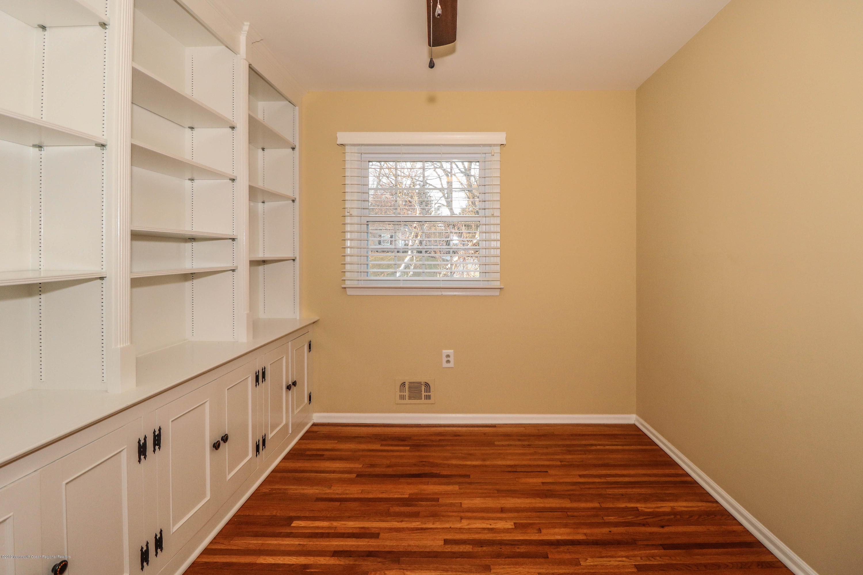 15 Middlebrook Drive Asbury Park, NJ 07712 - Photo 24 of 39 a view of an empty room with wooden floor and a window