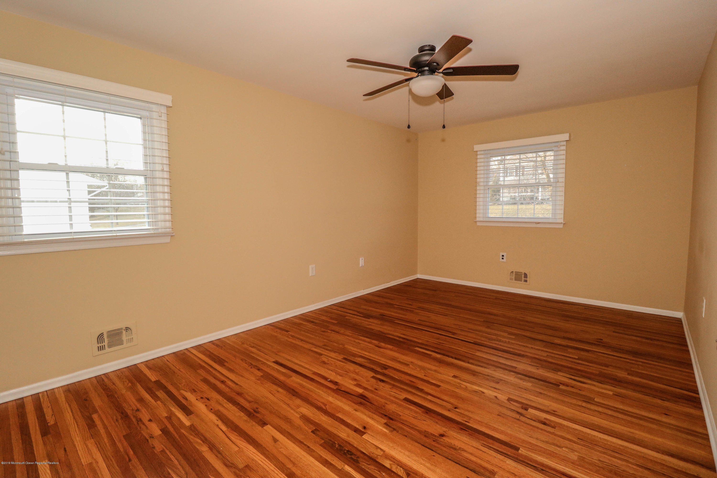 15 Middlebrook Drive Asbury Park, NJ 07712 - Photo 26 of 39 a view of a room with wooden floor and a ceiling fan
