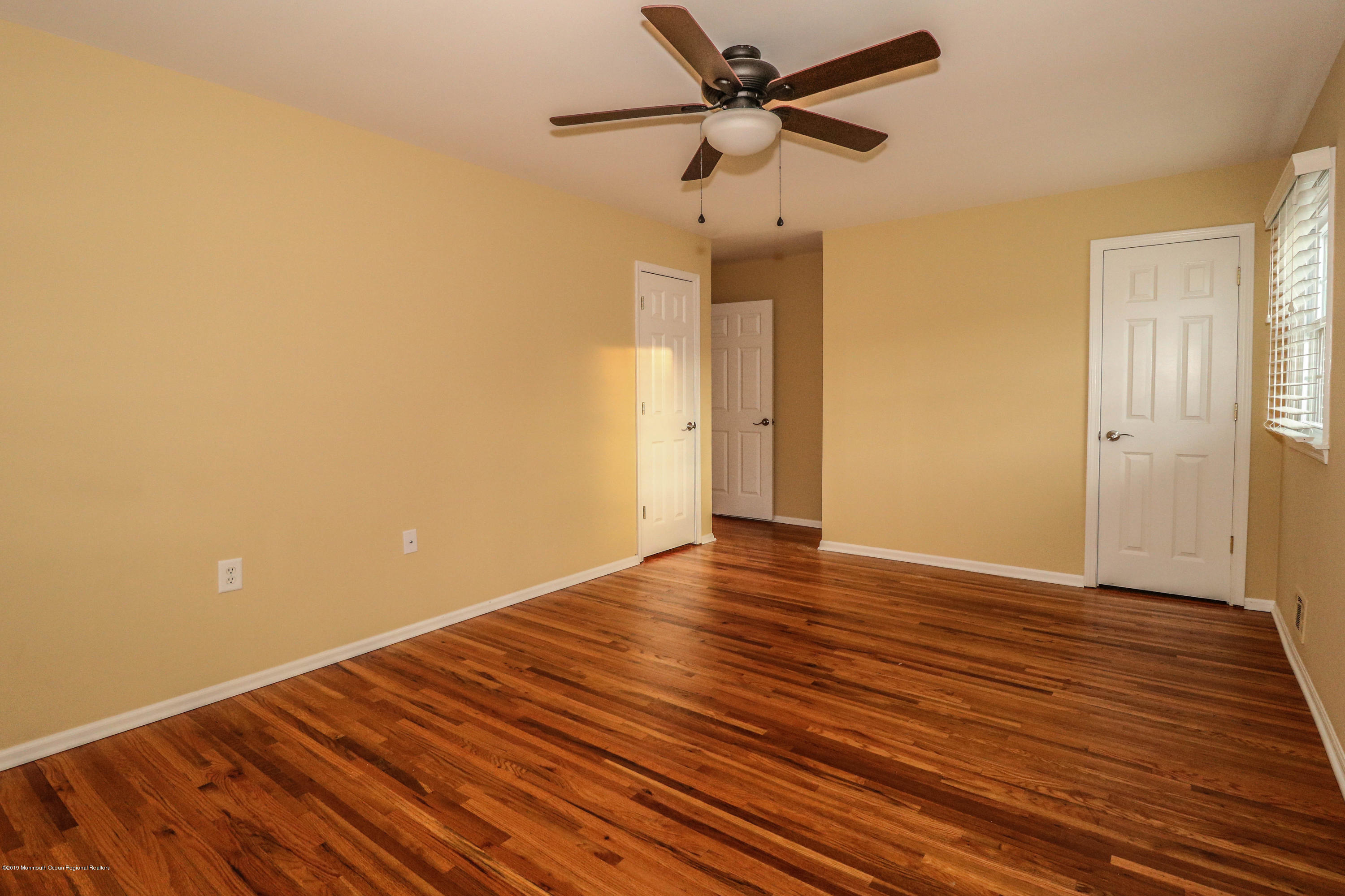 15 Middlebrook Drive Asbury Park, NJ 07712 - Photo 27 of 39 a view of room with wooden floor and a ceiling fan