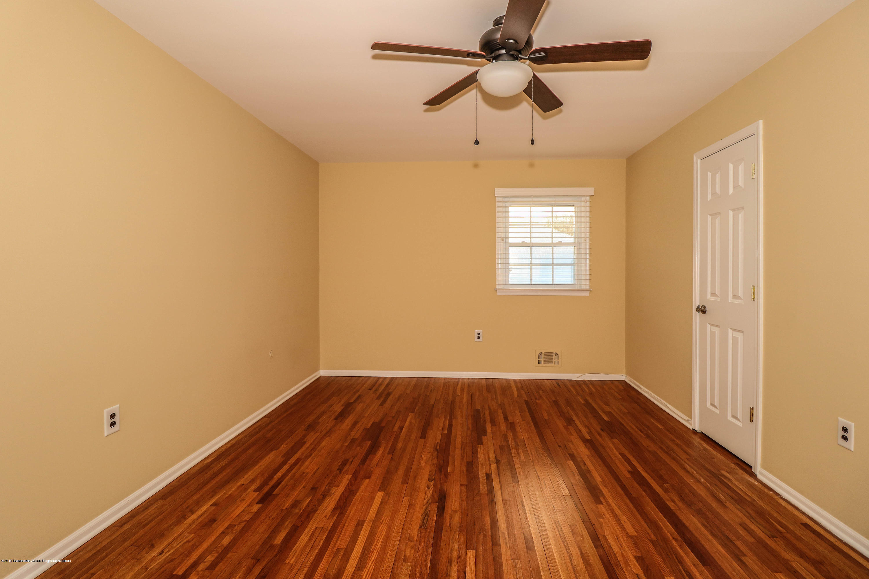 15 Middlebrook Drive Asbury Park, NJ 07712 - Photo 33 of 39 wooden floor in an empty room with a window
