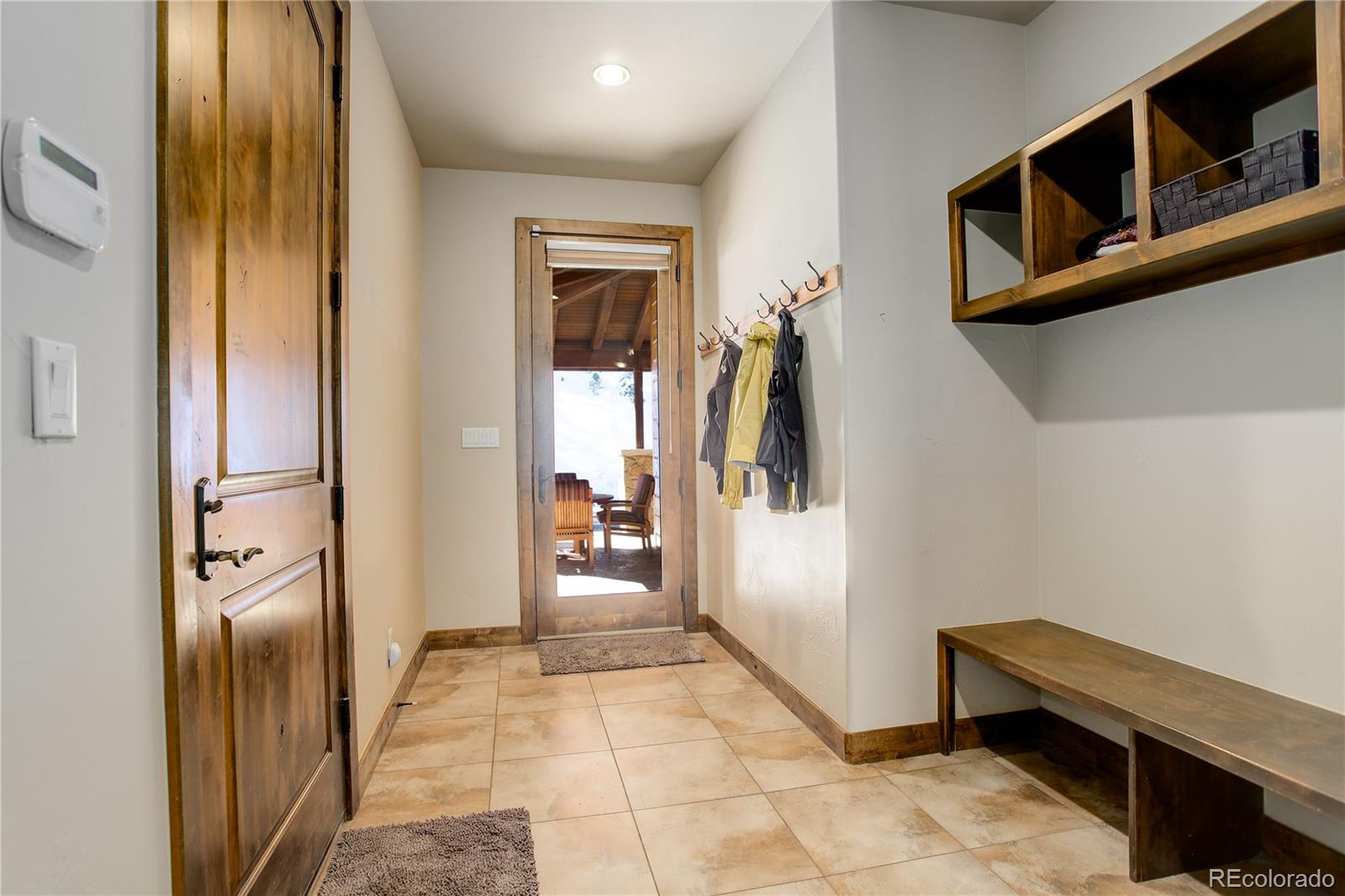 92 Whiskey Jay Hill Road Evergreen, CO 80439 - Photo 22 of 45 a view of entryway and hall with dining area