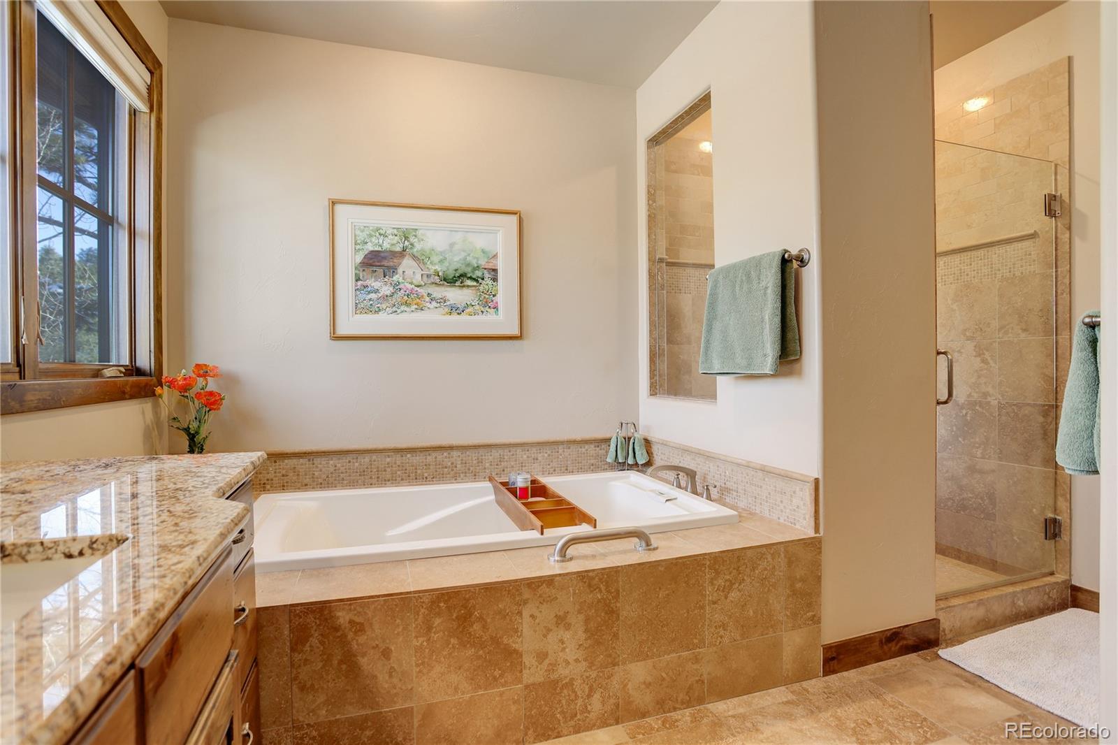 92 Whiskey Jay Hill Road Evergreen, CO 80439 - Photo 28 of 45 a bathroom with a tub and a sink