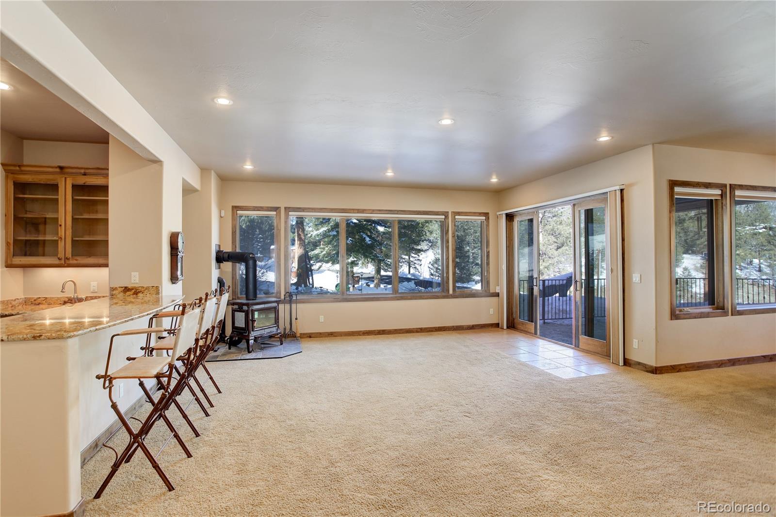 92 Whiskey Jay Hill Road Evergreen, CO 80439 - Photo 32 of 45 a view of game room with window and furniture