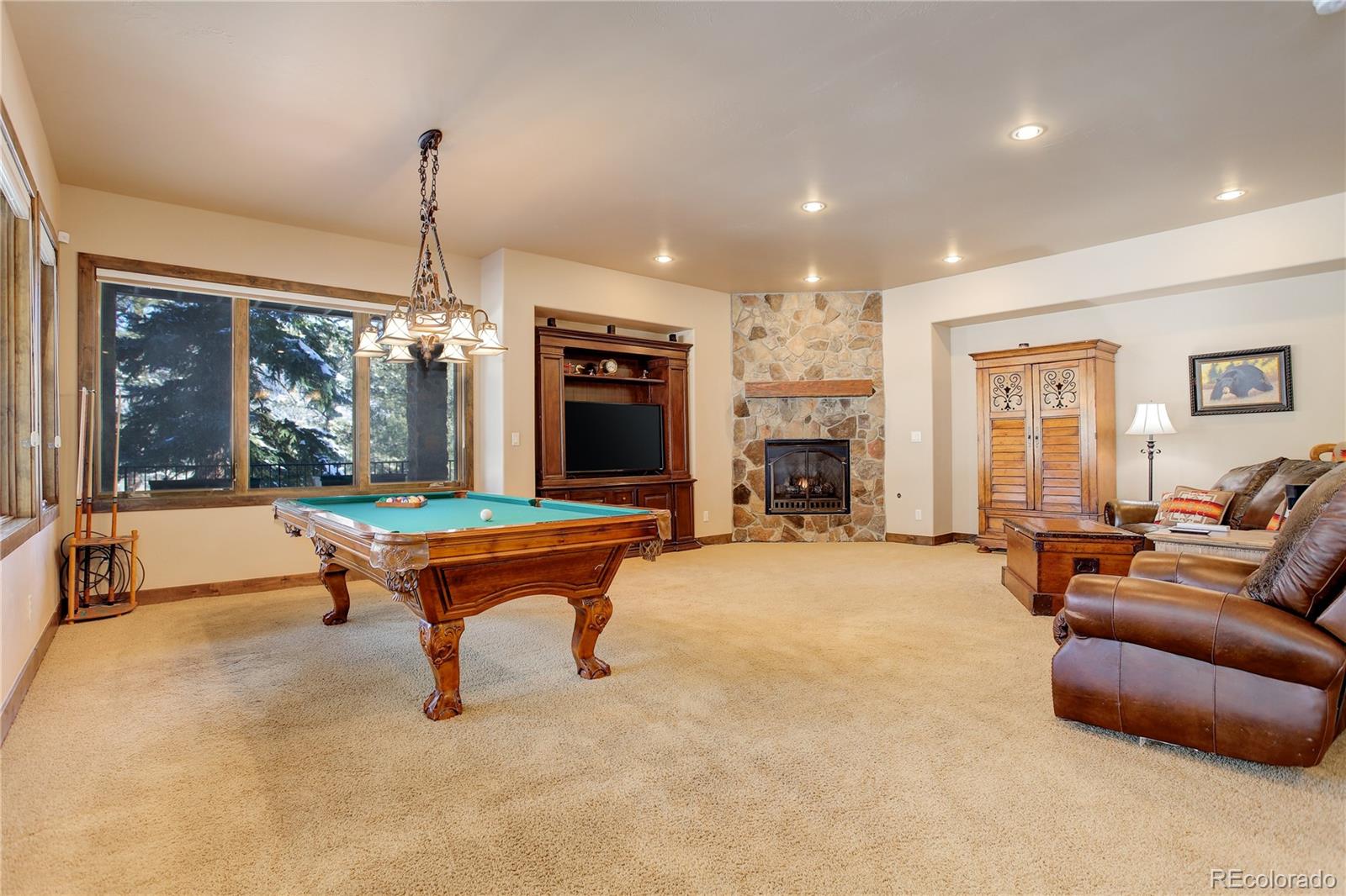 92 Whiskey Jay Hill Road Evergreen, CO 80439 - Photo 33 of 45 a room with pool table and a large window