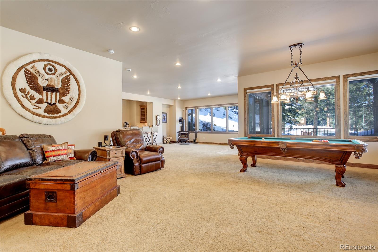 92 Whiskey Jay Hill Road Evergreen, CO 80439 - Photo 34 of 45 a living room with furniture a window and a clock