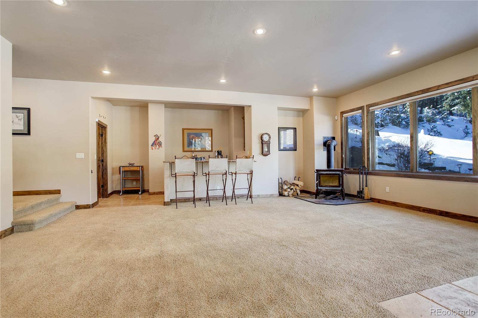 92 Whiskey Jay Hill Road Evergreen, CO 80439 - Photo 35 of 45 an empty room with furniture and a large window