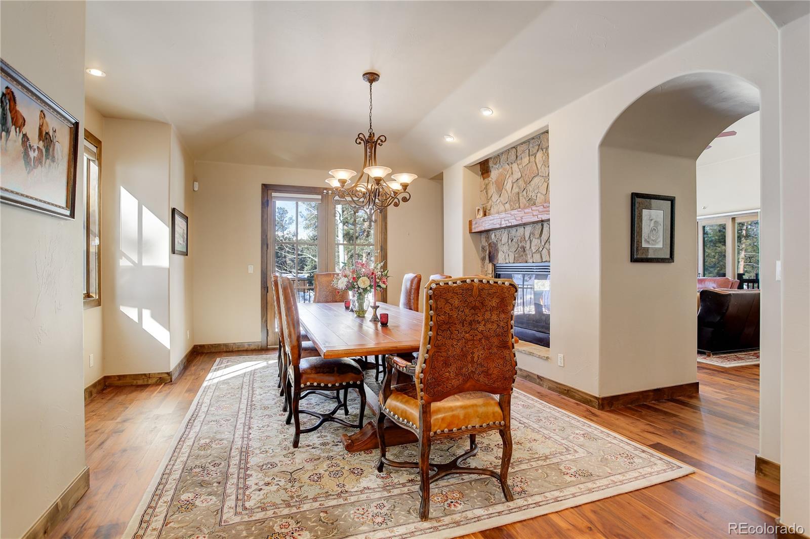92 Whiskey Jay Hill Road Evergreen, CO 80439 - Photo 7 of 45 a dining room with furniture a chandelier and wooden floor