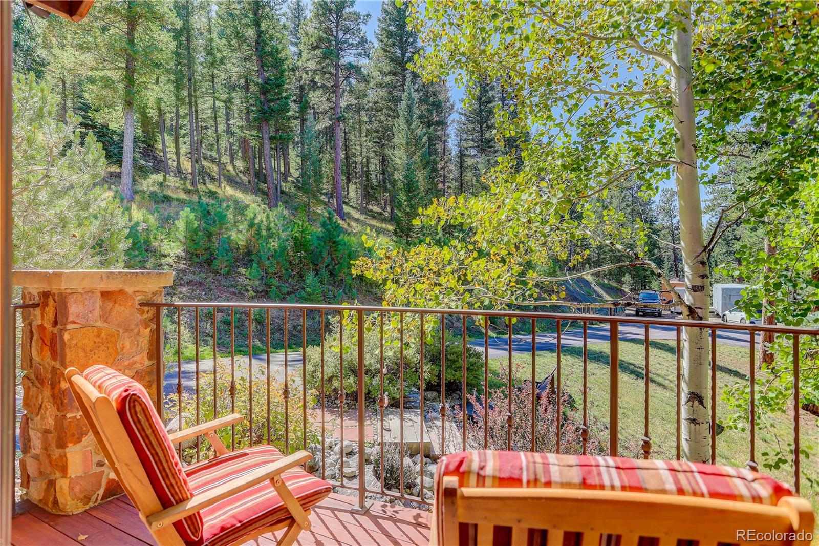 92 Whiskey Jay Hill Road Evergreen, CO 80439 - Photo 8 of 45 a balcony with chairs