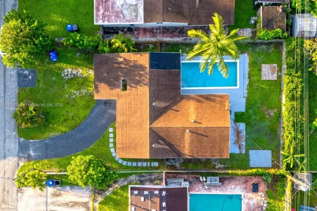 an aerial view of a house with a swimming pool