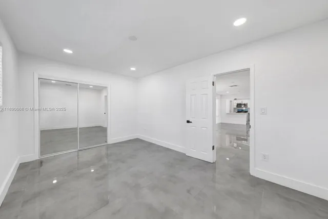 a view of a hallway with a bathroom