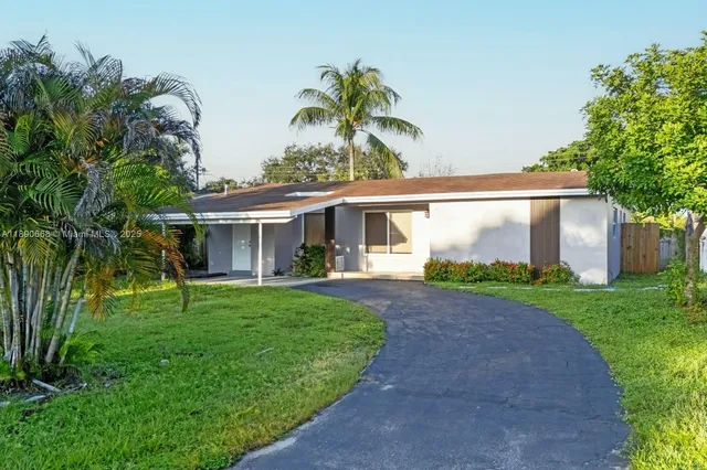 a front view of a house with a garden and porch