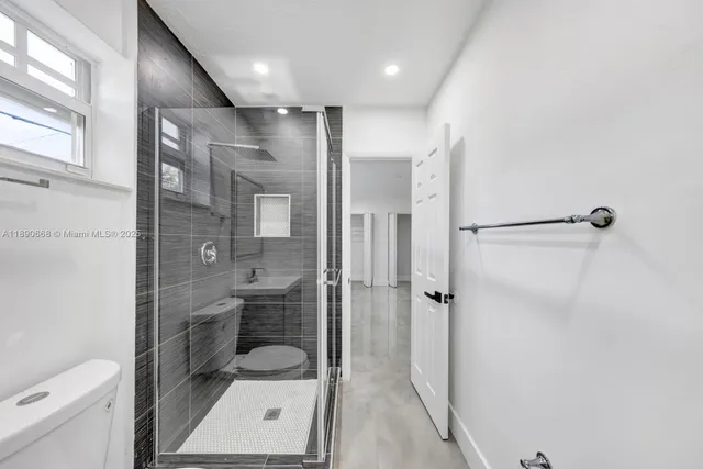 a bathroom with a toilet a sink and shower