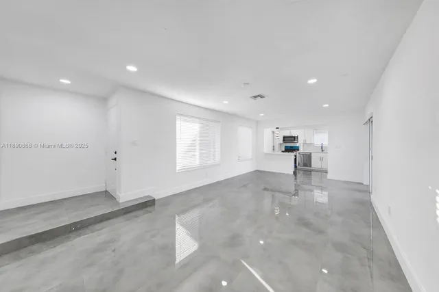 an empty room with large windows