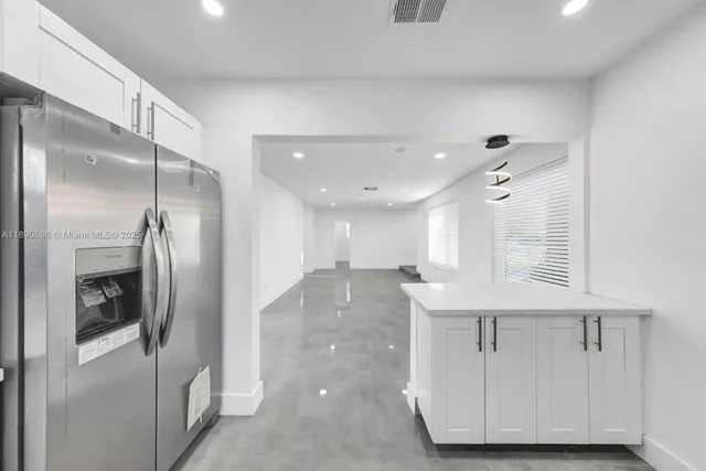 a kitchen with granite countertop a sink and stainless steel appliances