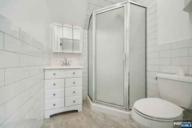 a bathroom with a toilet a sink and shower