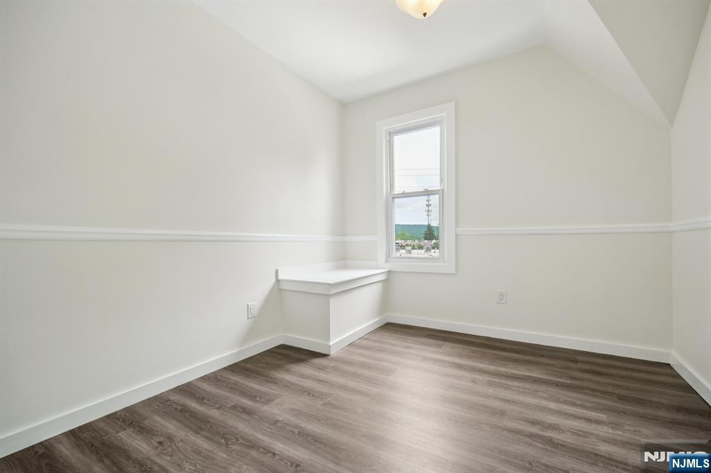 534 Durie Avenue, Unit 3 Closter, NJ 07624 - Photo 18 of 32 an empty room with wooden floor and windows