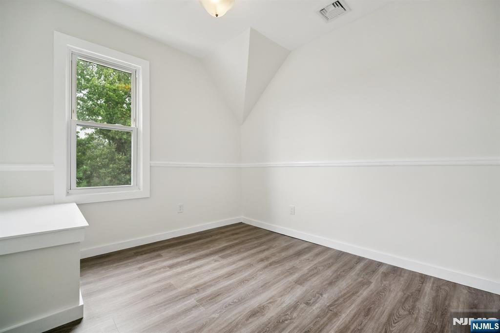 534 Durie Avenue, Unit 3 Closter, NJ 07624 - Photo 19 of 32 a view of a room that has wooden floor and a window