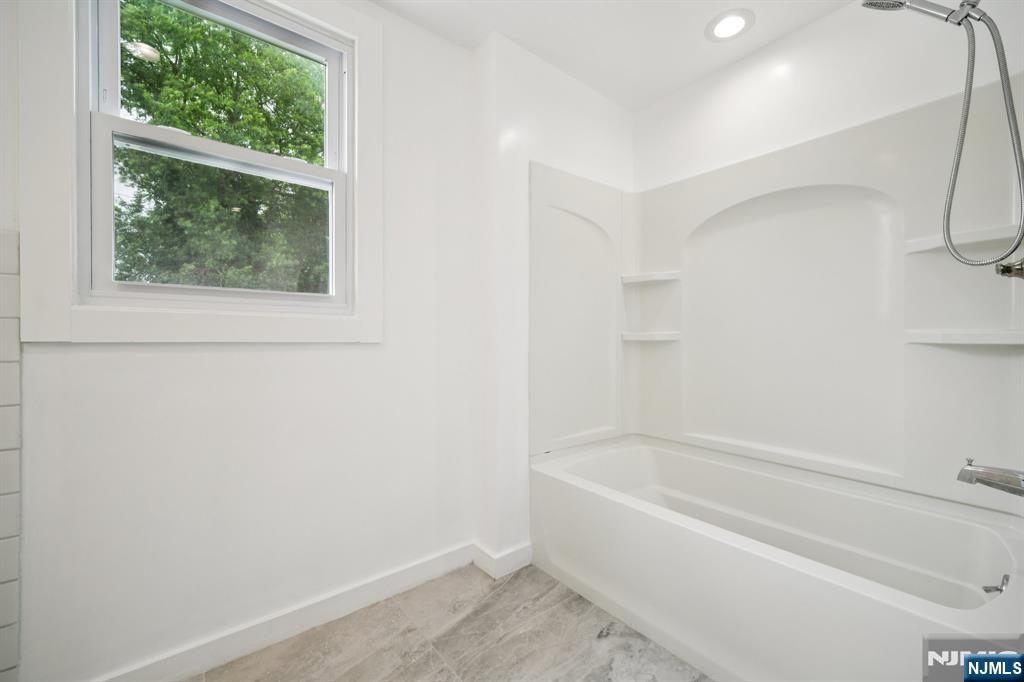 534 Durie Avenue, Unit 3 Closter, NJ 07624 - Photo 20 of 32 a white bath tub sitting next to a window