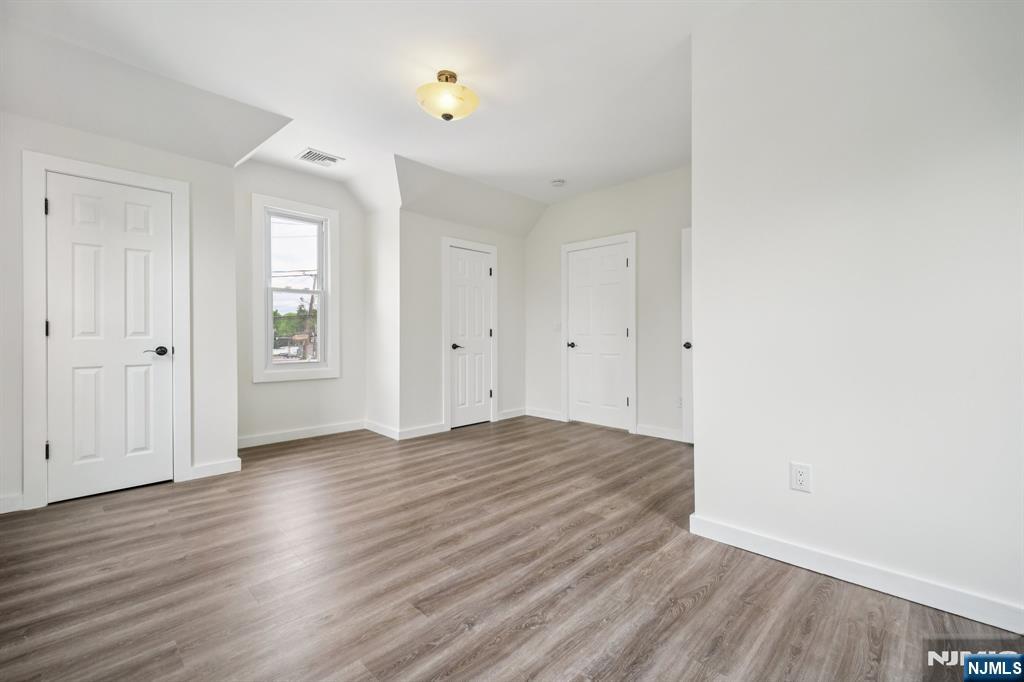 534 Durie Avenue, Unit 3 Closter, NJ 07624 - Photo 21 of 32 an empty room with wooden floor and windows
