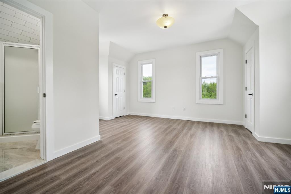 534 Durie Avenue, Unit 3 Closter, NJ 07624 - Photo 22 of 32 an empty room with wooden floor and windows