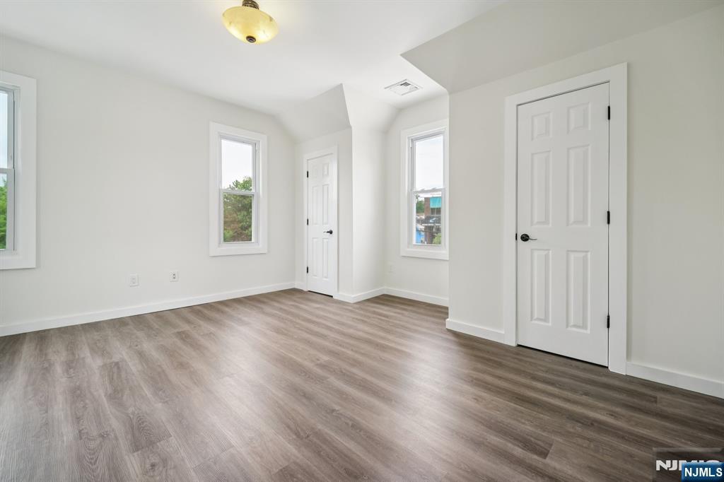 534 Durie Avenue, Unit 3 Closter, NJ 07624 - Photo 23 of 32 an empty room with wooden floor and windows