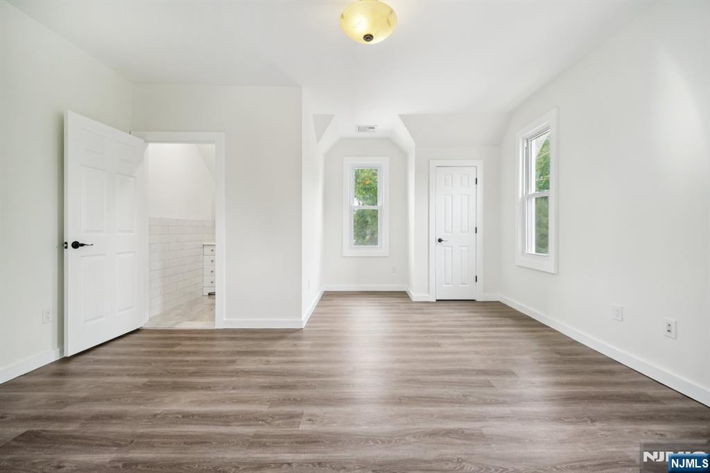 534 Durie Avenue, Unit 3 Closter, NJ 07624 - Photo 24 of 32 an empty room with wooden floor and windows