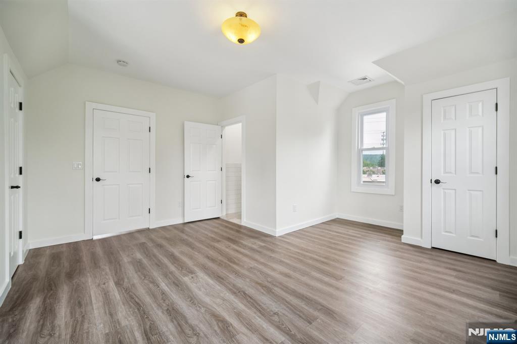 534 Durie Avenue, Unit 3 Closter, NJ 07624 - Photo 25 of 32 an empty room with wooden floor and windows