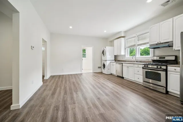 a kitchen with wooden floors and white appliances