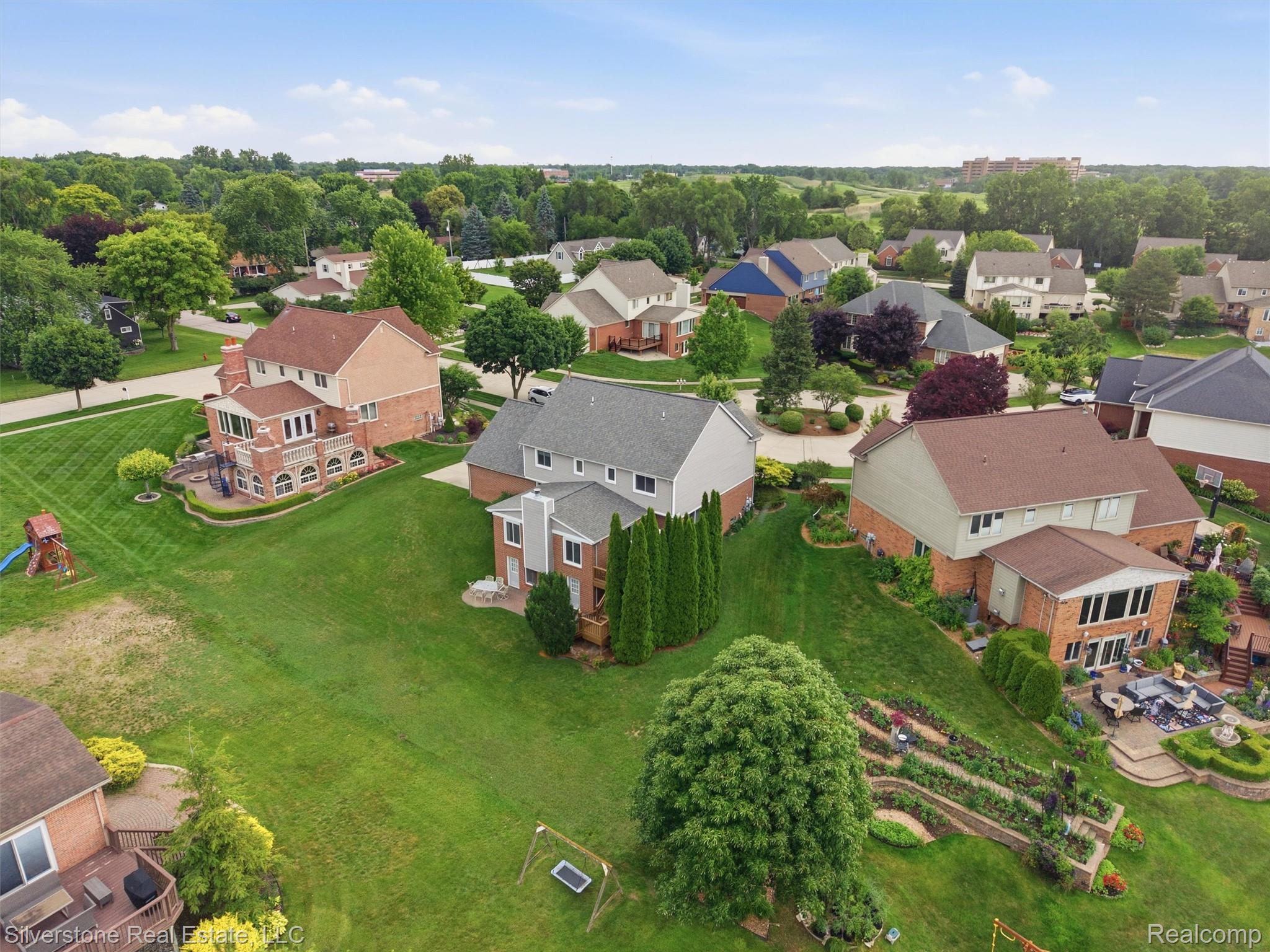 6577 Edith Court Troy, MI 48085 - Photo 59 of 61 Expansive residential property featuring a multi-level terraced garden, mature trees, and a spacious green lawn