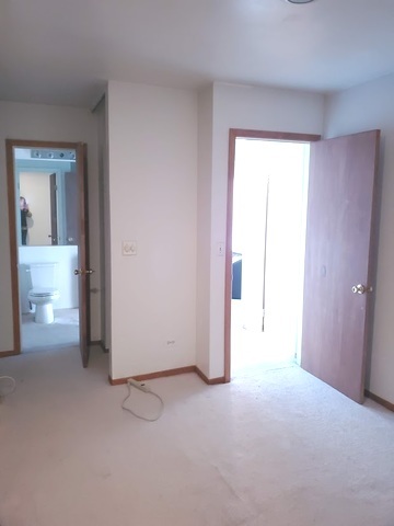 324 Inverrary Lane, Unit D Deerfield, IL 60015 - Photo 19 of 32 a view of a room with a hallway and two windows
