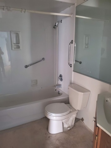 324 Inverrary Lane, Unit D Deerfield, IL 60015 - Photo 27 of 32 a white toilet sitting next to a bath tub shower