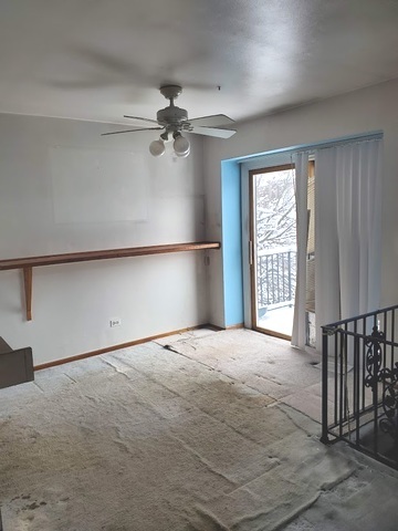 324 Inverrary Lane, Unit D Deerfield, IL 60015 - Photo 8 of 32 an empty room with windows and fan