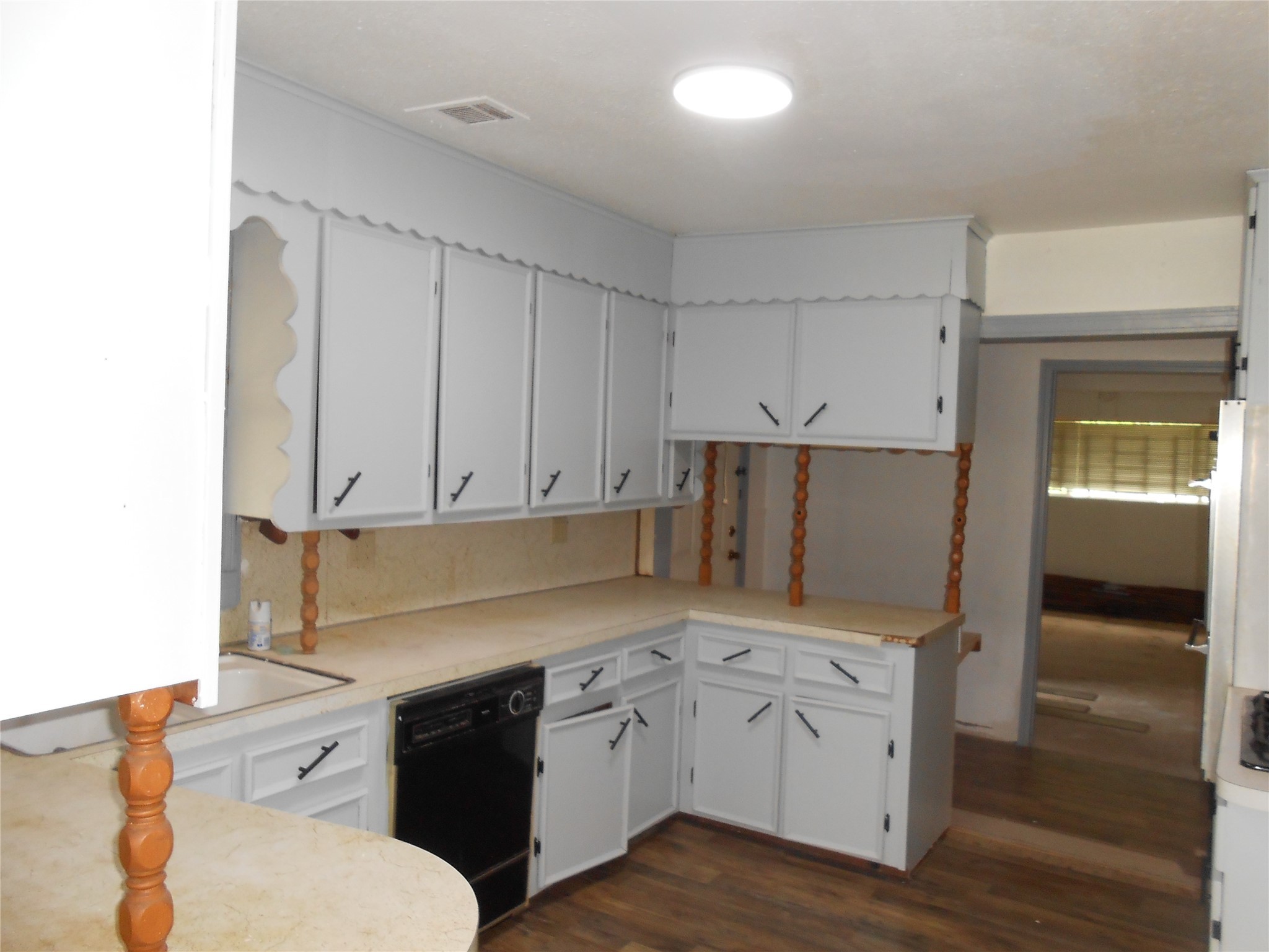 930 West 5th Street Port Arthur, TX 77640 - Photo 5 of 15 a kitchen with granite countertop white cabinets and white appliances