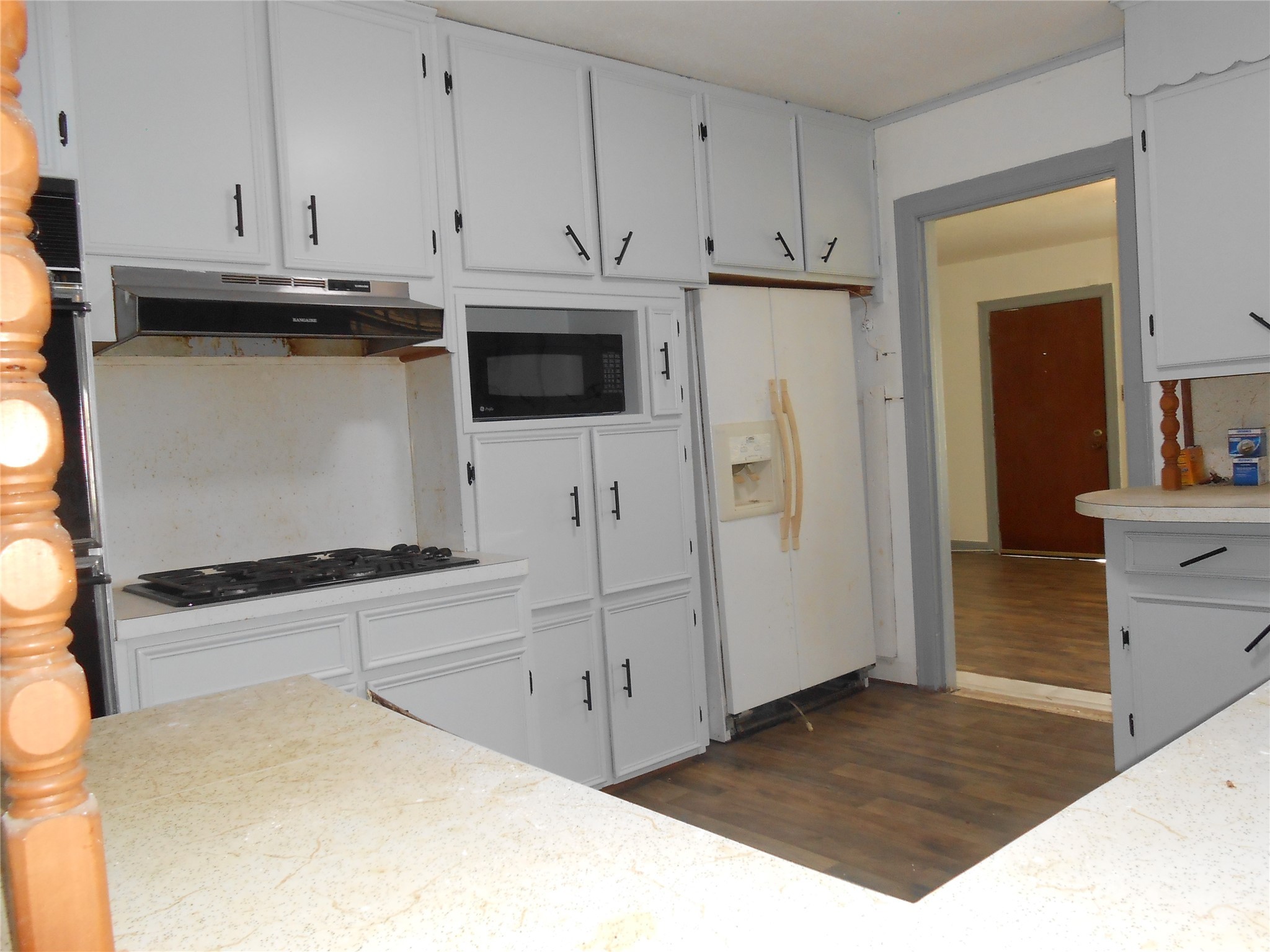 930 West 5th Street Port Arthur, TX 77640 - Photo 6 of 15 a kitchen with stainless steel appliances granite countertop a refrigerator sink and white cabinets