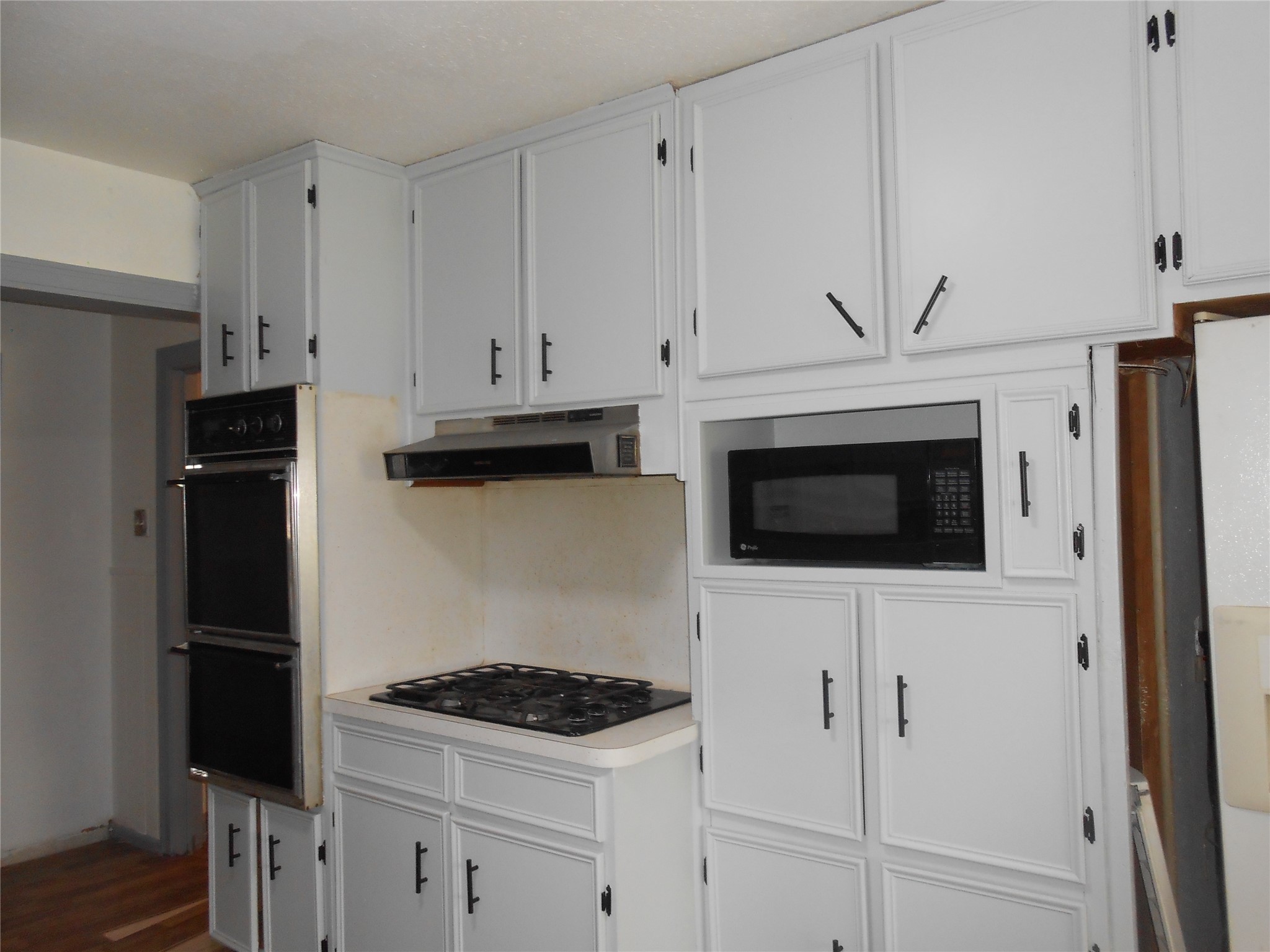 930 West 5th Street Port Arthur, TX 77640 - Photo 7 of 15 a kitchen with stainless steel appliances white cabinets and a stove