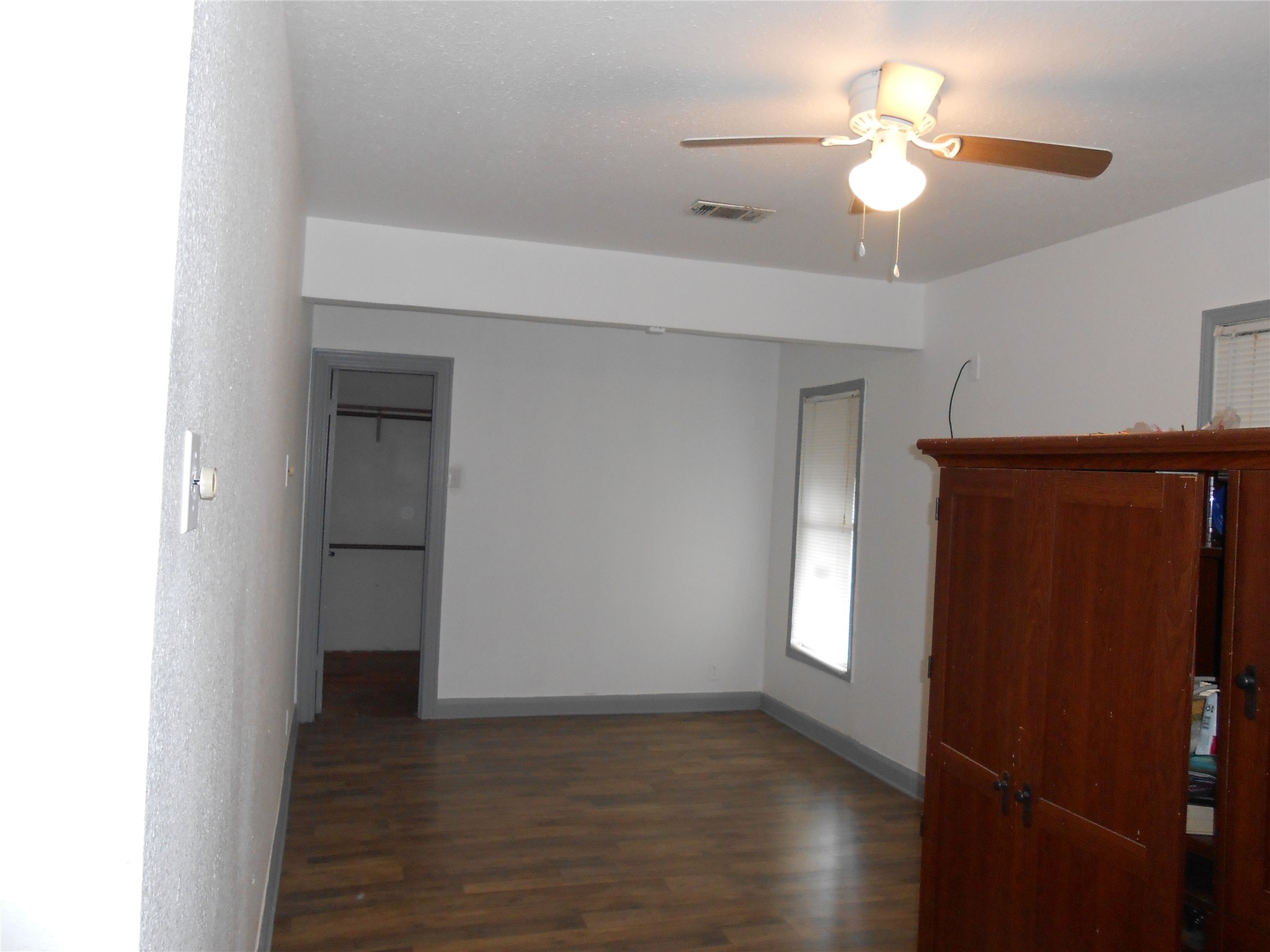 930 West 5th Street Port Arthur, TX 77640 - Photo 8 of 15 a view of an empty room with a window and wooden floor