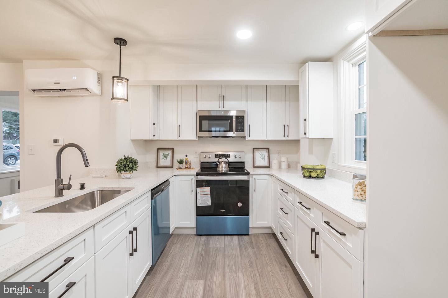115 Beech Road Wallingford, PA 19086 - Photo 11 of 29 a kitchen with cabinets stainless steel appliances a sink and a stove