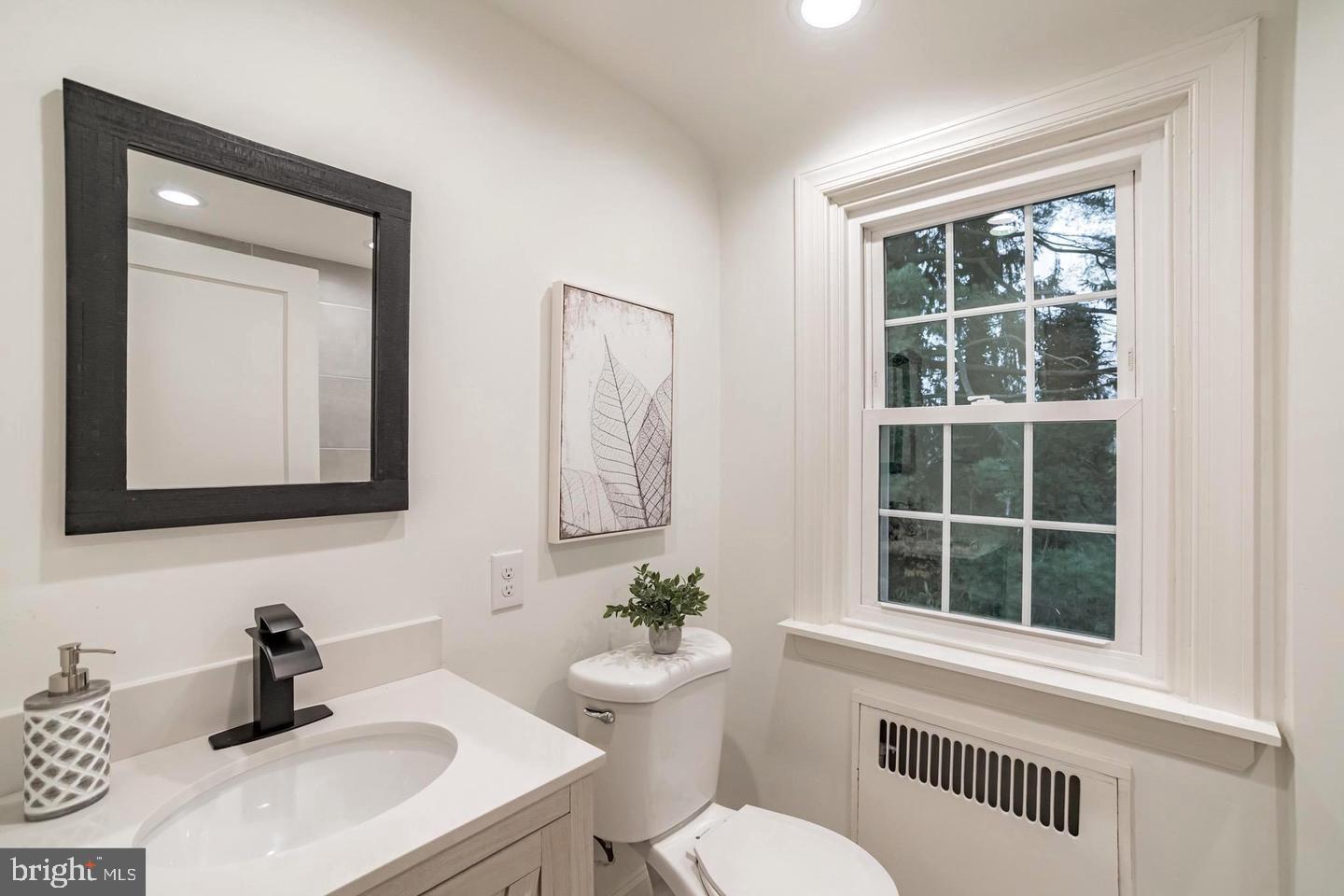 115 Beech Road Wallingford, PA 19086 - Photo 18 of 29 a bathroom with a sink a toilet and a window