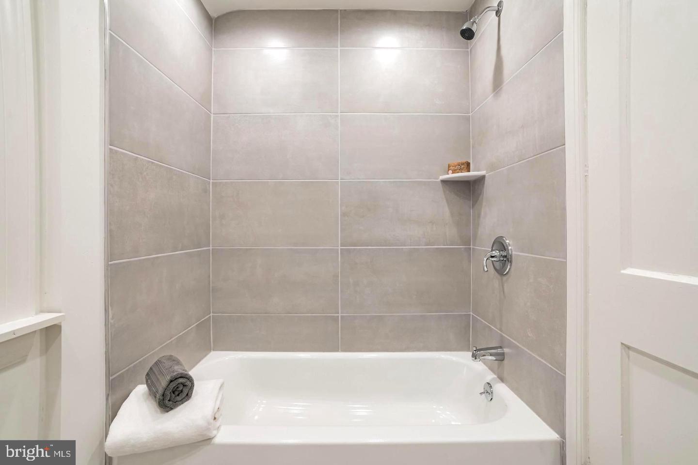 115 Beech Road Wallingford, PA 19086 - Photo 19 of 29 a bath tub sitting next to a white sink and vanity