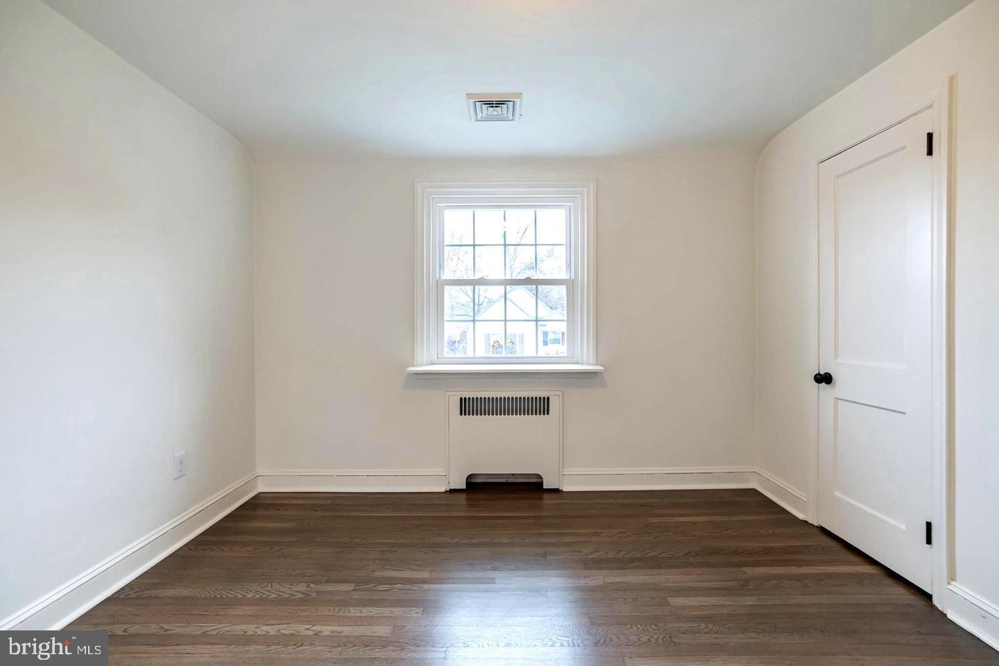 115 Beech Road Wallingford, PA 19086 - Photo 20 of 29 an empty room with wooden floor and windows