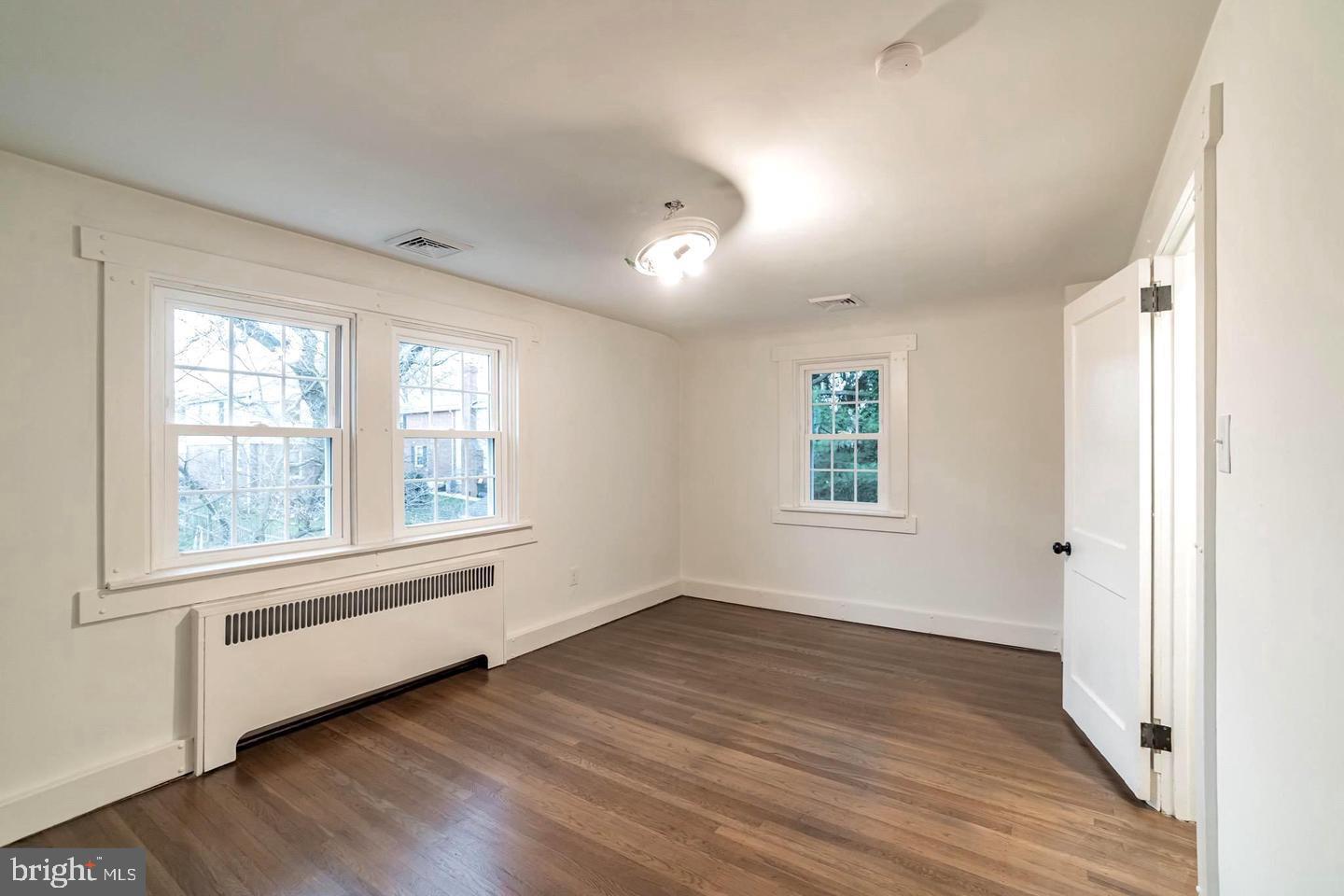115 Beech Road Wallingford, PA 19086 - Photo 21 of 29 an empty room with wooden floor and windows