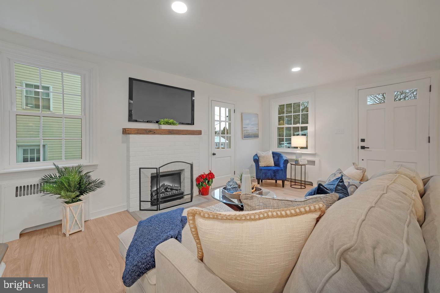 115 Beech Road Wallingford, PA 19086 - Photo 6 of 29 a living room with furniture fireplace and potted plants