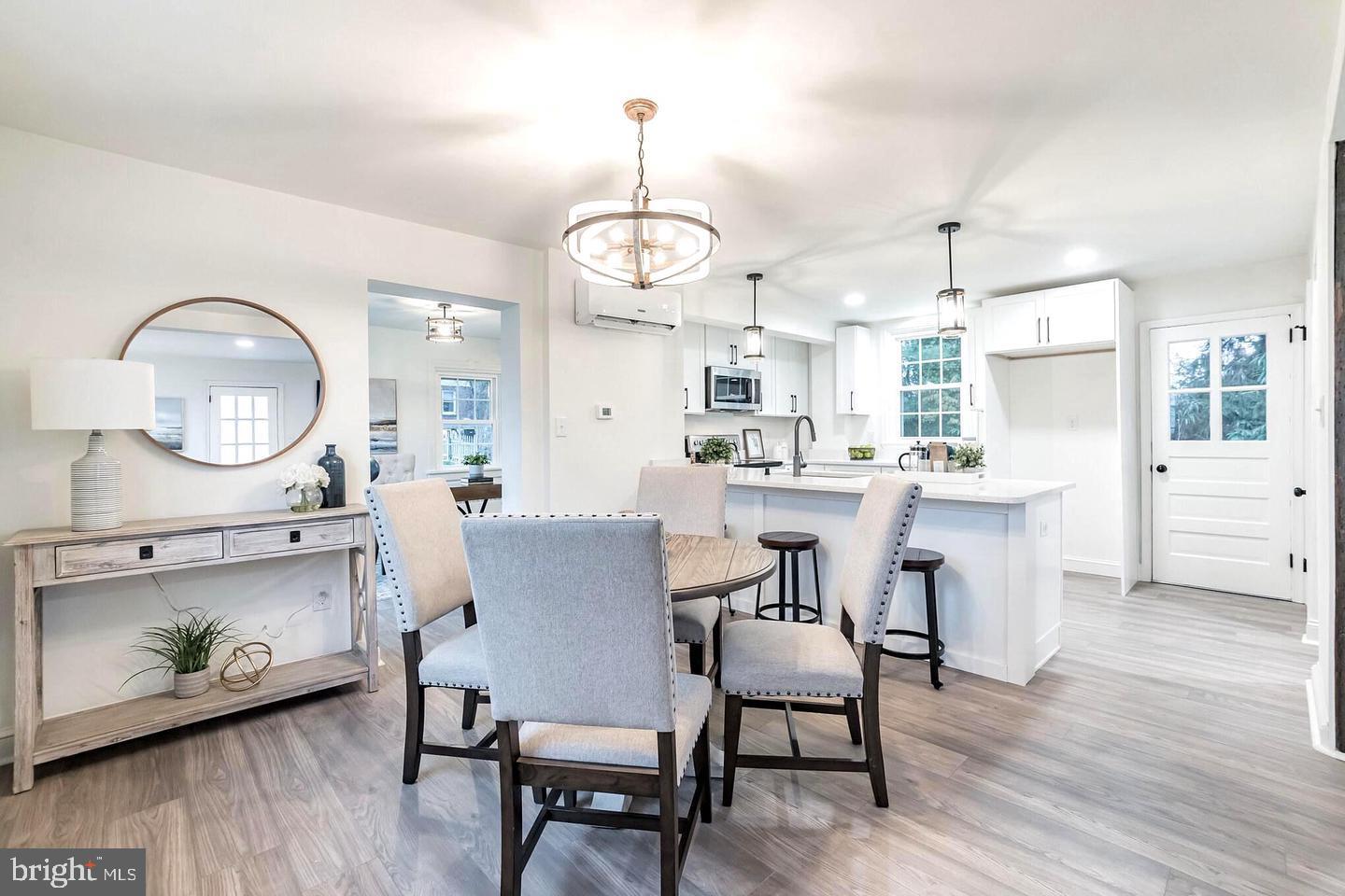 115 Beech Road Wallingford, PA 19086 - Photo 7 of 29 a dining room with wooden floor a glass table and chairs